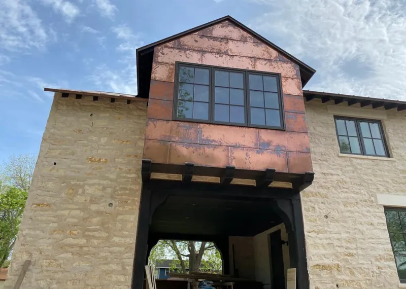 Copper metal panel facade on a stone building for Roof Repair in Oregon